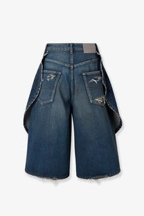 Balenciaga women’s blue cotton bermuda shorts with dark denim, distressed frayed edges, and asymmetrical overlapping panels