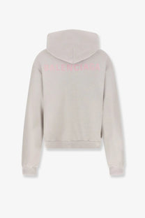 Balenciaga women’s cotton hooded sweatshirt white shown from the back with soft beige fabric and pink embroidered logo