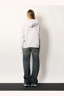 Balenciaga women’s cotton hooded sweatshirt white shown from the back with a soft light gray fabric and subtle pink logo