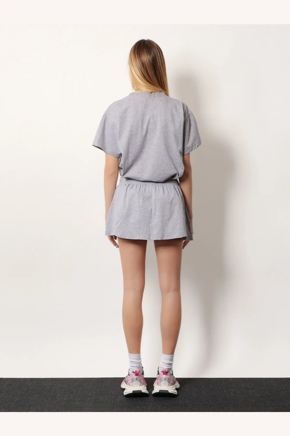 Balenciaga womens grey cotton miniskirt paired with gray cotton t-shirt and elastic waistband shorts loungewear set