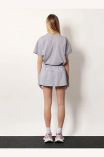 Balenciaga womens grey cotton miniskirt paired with gray cotton t-shirt and elastic waistband shorts loungewear set