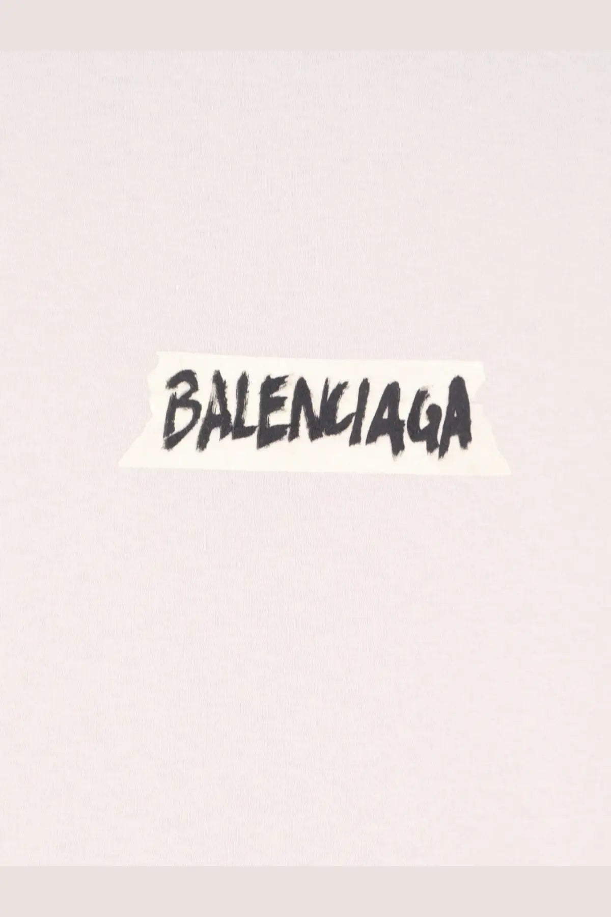 Black handwritten balenciaga logo on torn white paper sticker on balenciaga women’s white cotton shirt