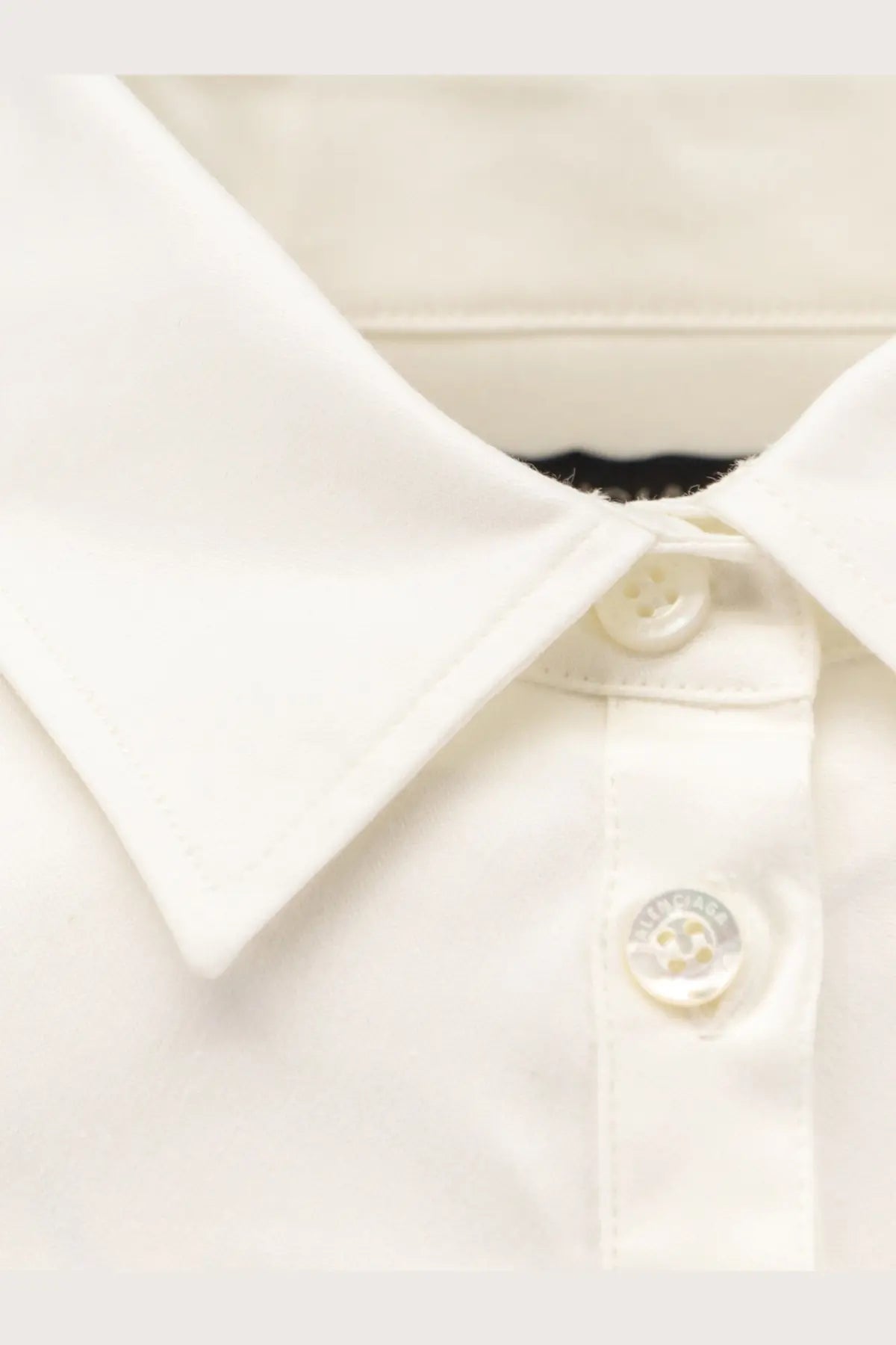 Balenciaga women’s white cotton shirt with a classic collar and subtle stitching details in a crisp button-down style