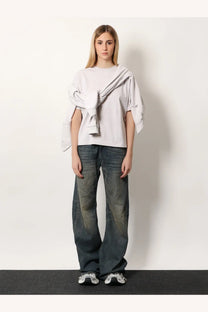 Balenciaga women’s white cotton shirt styled as a light gray oversized sweatshirt with draped asymmetrical design