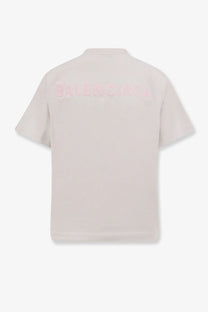 Balenciaga women’s cotton shirt white showing back with pale pink short-sleeved polo and subtle matching logo embroidery