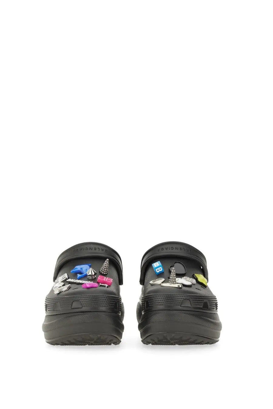 Balenciaga women’s black crocs clogs with colorful metallic jibbitz charms and accessories displayed from the back