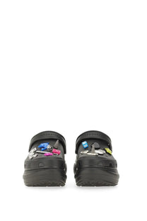 Balenciaga women’s black crocs clogs with colorful metallic jibbitz charms and accessories displayed from the back