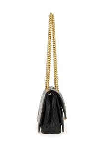 Balenciaga women’s crush small bag black quilted leather handbag with gold-tone chain strap visible from front