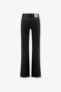 Balenciaga women’s black denim trousers with straight-leg cut and frayed hems made from premium denim material