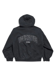 Back view of black balenciaga womens flipped zippered sweatshirt with white outlined paris lettering on hoodie