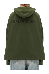 Back side of olive green balenciaga women’s hooded jacket with logo print across the back