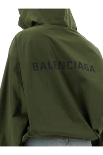 Back view of olive green balenciaga women’s hooded jacket with bold black lettering across the back