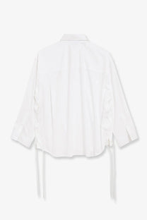Balenciaga women’s white cotton blouse with ruffled sleeves and tie-back details shown from the back