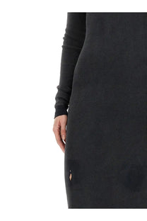 Balenciaga women’s long black ribbed knit dress with a small tear near the hem visible on the front side