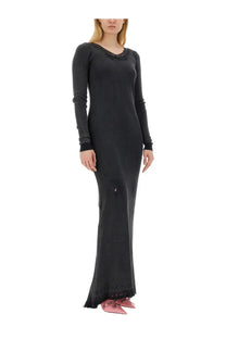 Balenciaga women’s black ribbed long-sleeved dress with lace trim at neckline and hem worn with pink shoes