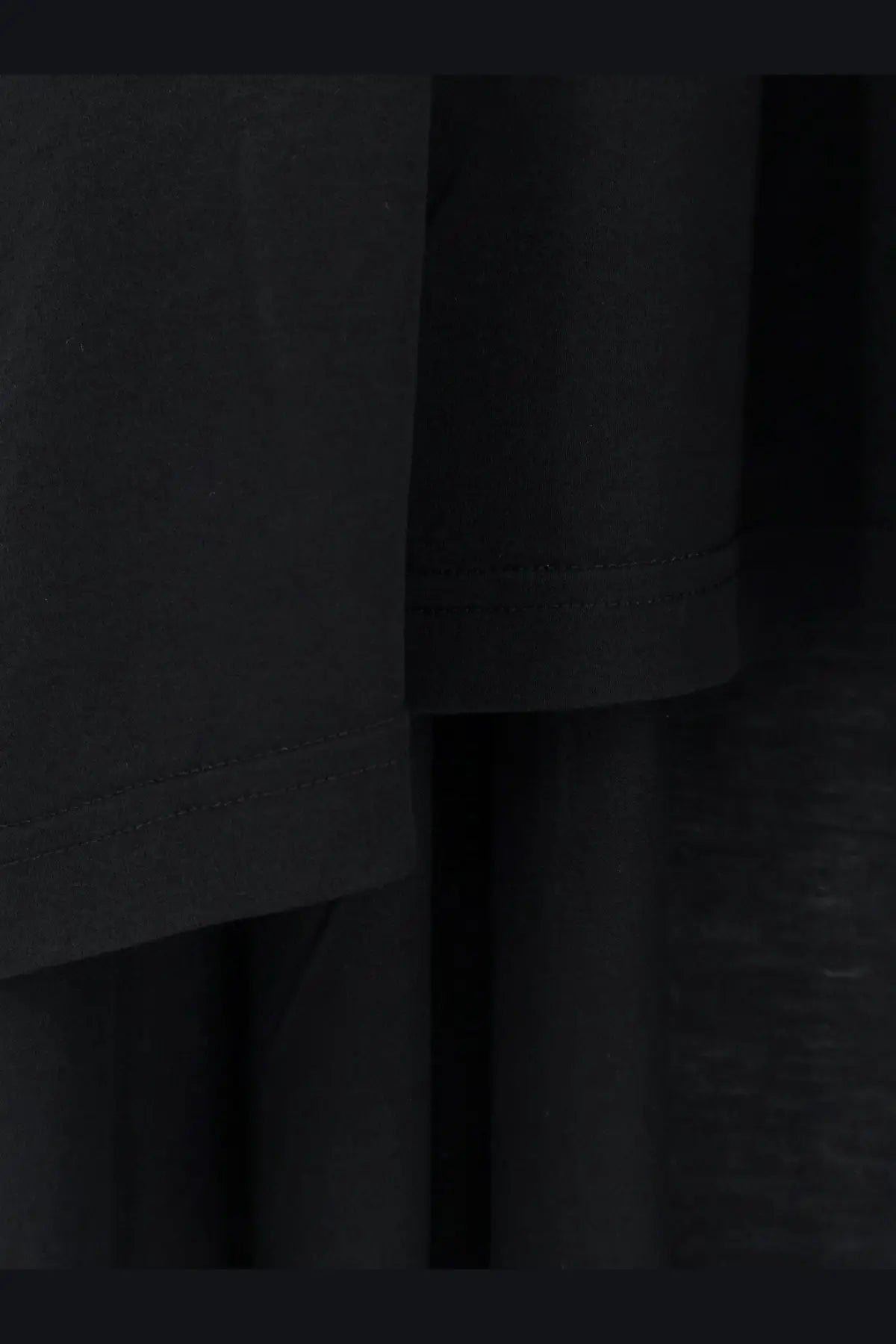 Balenciaga women’s long jersey shirt in black featuring subtle stitching detail on soft fabric