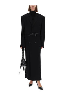 Balenciaga women’s black long sartorial skirt paired with a structured double-breasted coat with wide shoulders and belt