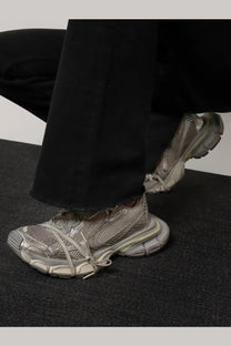 Balenciaga women’s low top white mesh sneakers with gray chunky layered sole and intricately tied laces