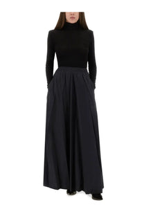 Balenciaga women’s black high-neck long-sleeve top paired with matching pleated maxi skirt in front view