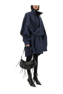 Black leather balenciaga moon bag with fringed detailing and metallic hardware featured with blue mini shirt style dress