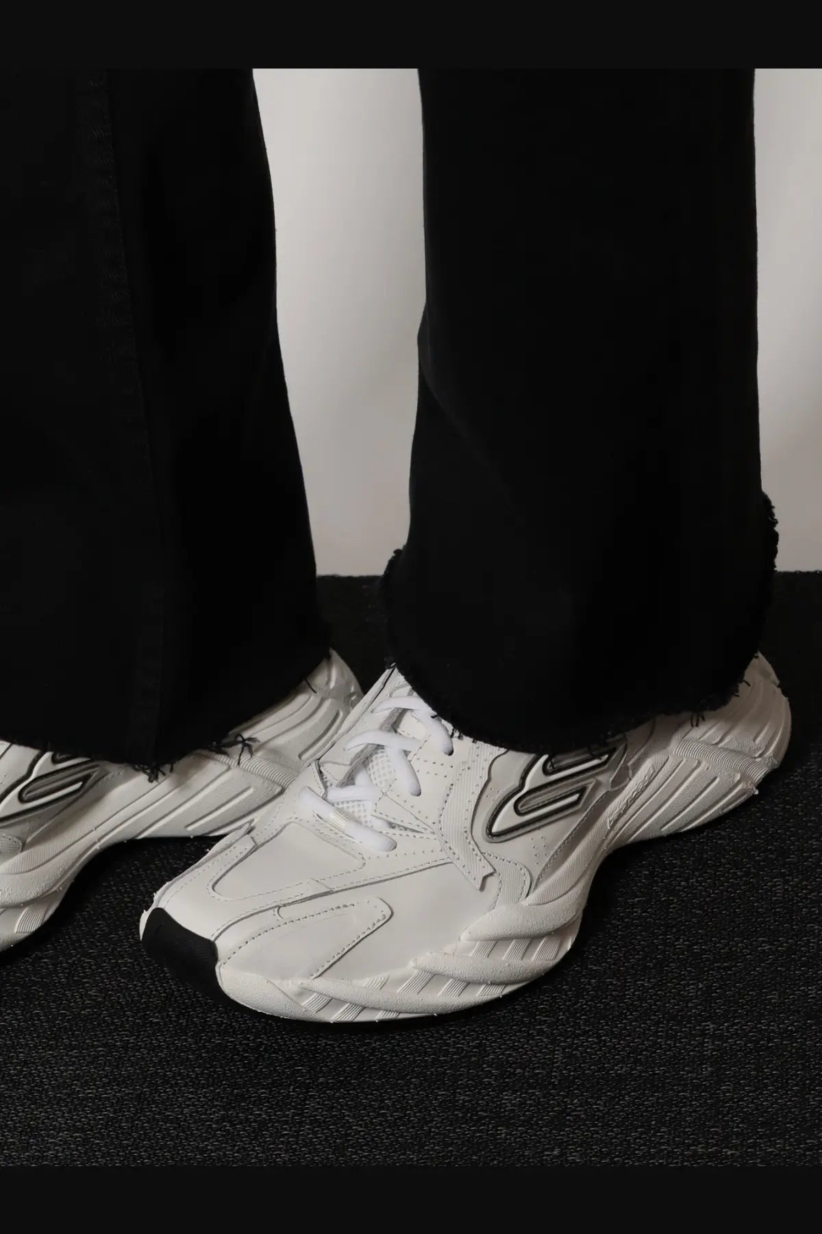 Balenciaga women’s monday low top sneakers in white leather with black accents and bold angular design