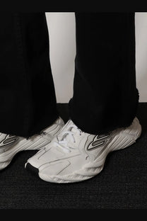 Balenciaga women’s monday low top sneakers in white leather with black accents and bold angular design