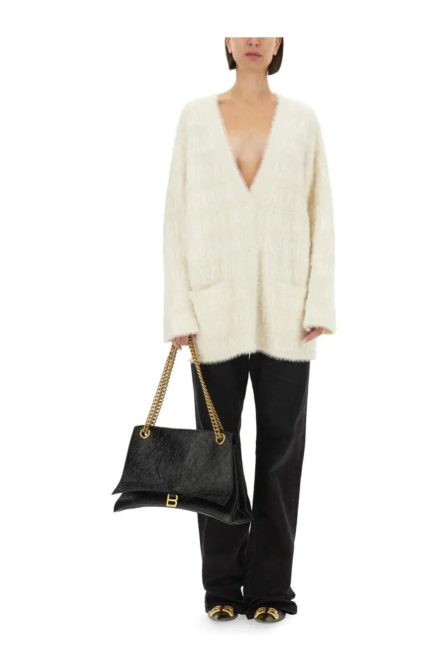 Black leather handbag with gold chain strap and embossed logo for balancing style and function