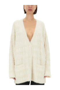 Balenciaga women’s cream-colored fluffy knit cardigan with deep v-neck and front pockets in white cream color