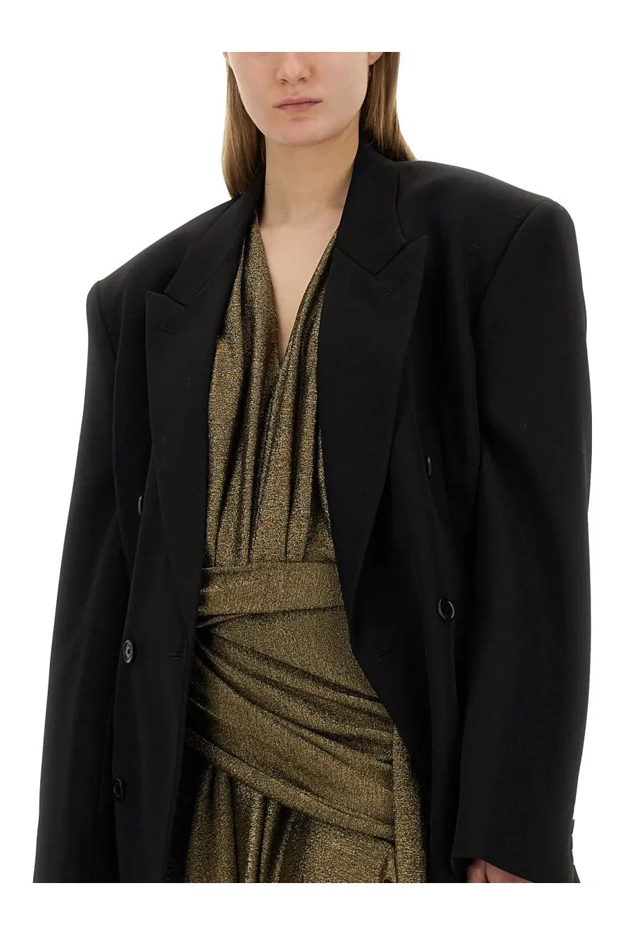 Balenciaga women’s black oversized blazer with structured shoulders and double-breasted buttons over metallic gold dress
