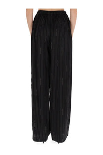 Balenciaga women’s black pyjama pants with wide-leg fit subtle vertical pinstripes and stretchy elastic waistband
