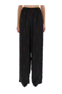 Balenciaga women’s black wide-leg pyjama pants with thin metallic vertical stripes and a relaxed fit