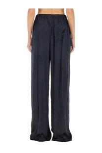 Balenciaga women’s pants pyjama blue featuring black satin wide-leg trousers with a relaxed fit and elastic waistband
