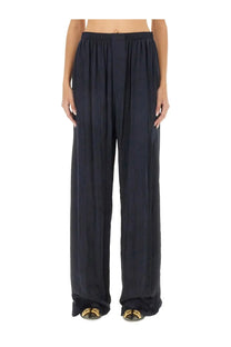 Balenciaga women’s black wide-leg trousers with relaxed flowing silhouette and elastic waistband in pyjama style