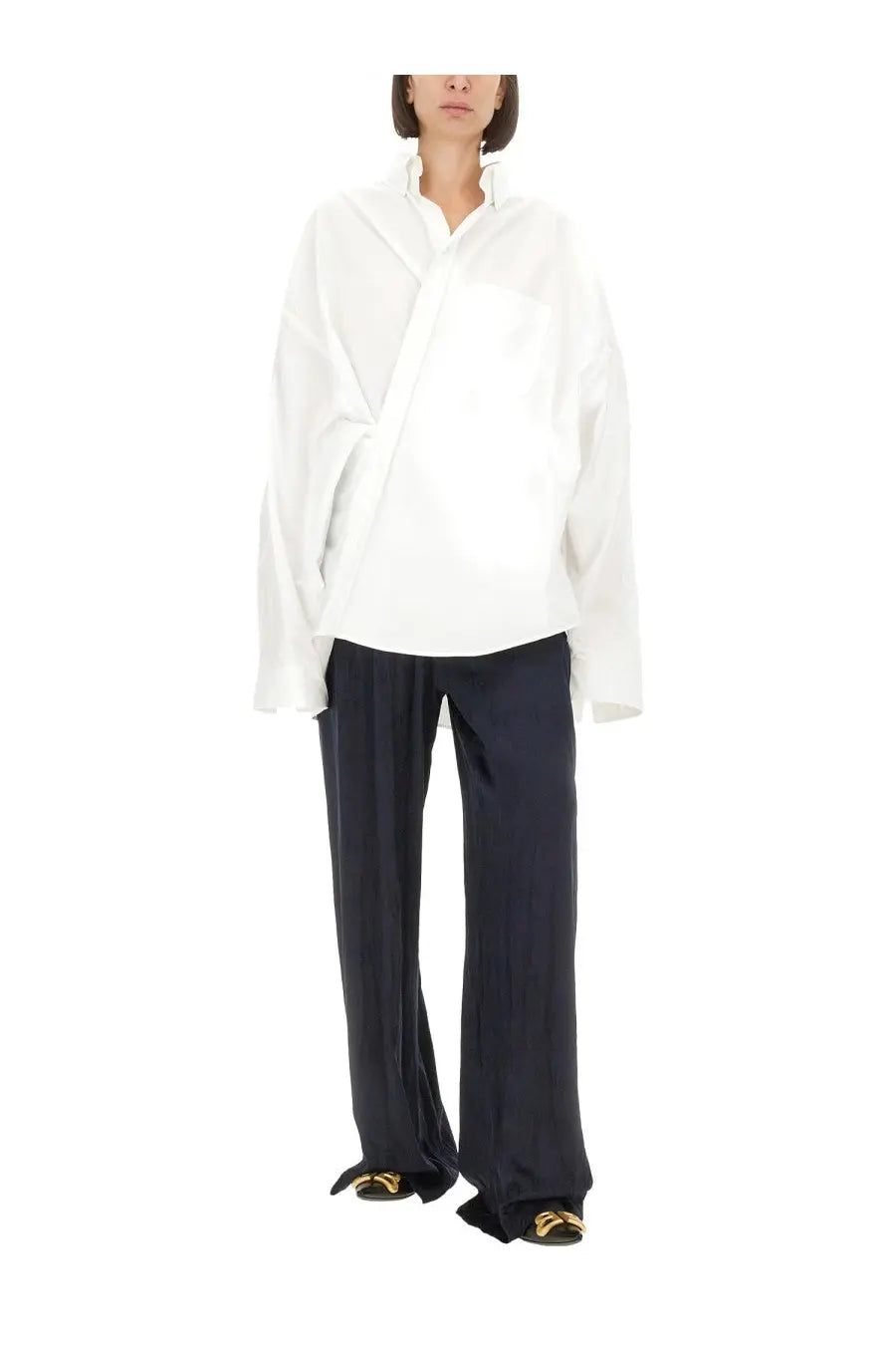 White oversized blouse with relaxed draped silhouette and long sleeves paired with balenciaga womens blue pyjama pants