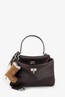 Balenciaga women’s rodeo dark brown leather crossbody bag with silver hardware and tan boot-shaped keychain