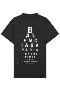Balenciaga women’s black t-shirt featuring a bold white eye chart print with brand name and details