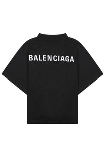 Back side of balenciaga women’s black t-shirt made of soft cotton with bold white lettering across the back