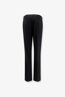 Balenciaga women’s slim tailored black wool trousers with straight-leg cut and subtle back pleats shown from rear view