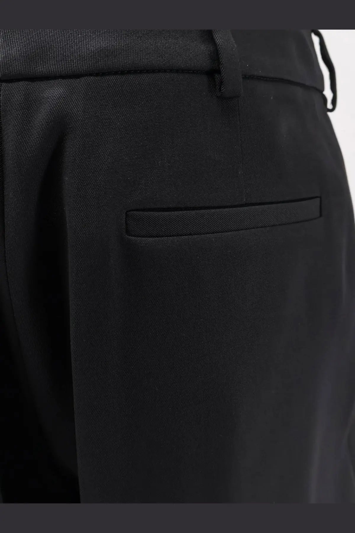 Balenciaga women’s slim tailored black wool trousers with subtle pleat and matching belt loop in textured fabric