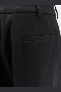 Balenciaga women’s slim tailored black wool trousers with textured fabric subtle pleat and matching belt loop
