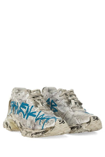 Balenciaga women’s white sneaker runner with worn-out blue graffiti-style lettering and size 38 mark on the toe