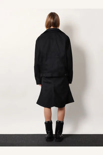 Balenciaga women’s black standing denim jacket with structured collar and buttoned cuffs paired with flared skirt