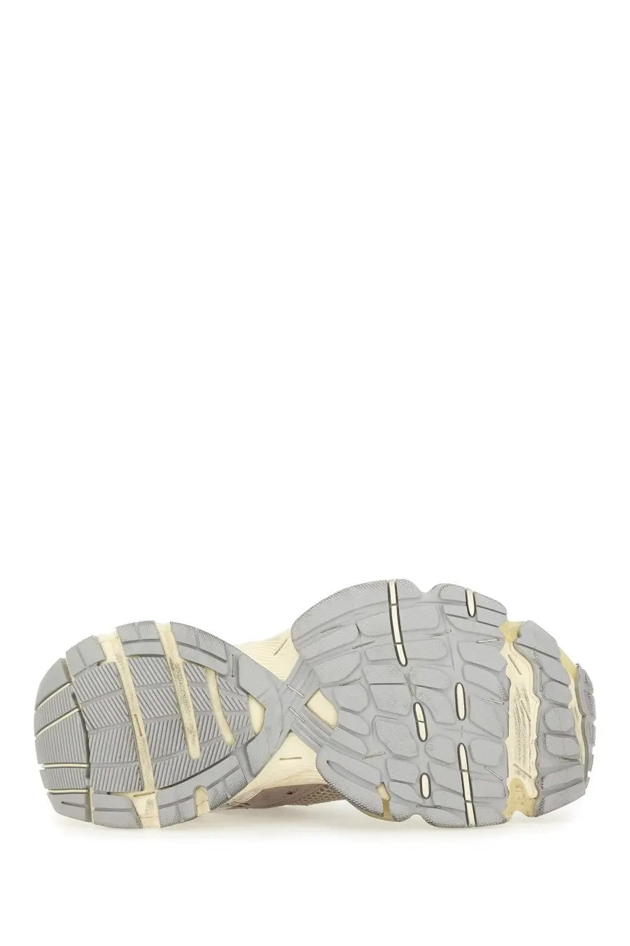 Beige and gray chunky sole with textured tread of balenciaga women’s stapler sneaker viewed from the back side