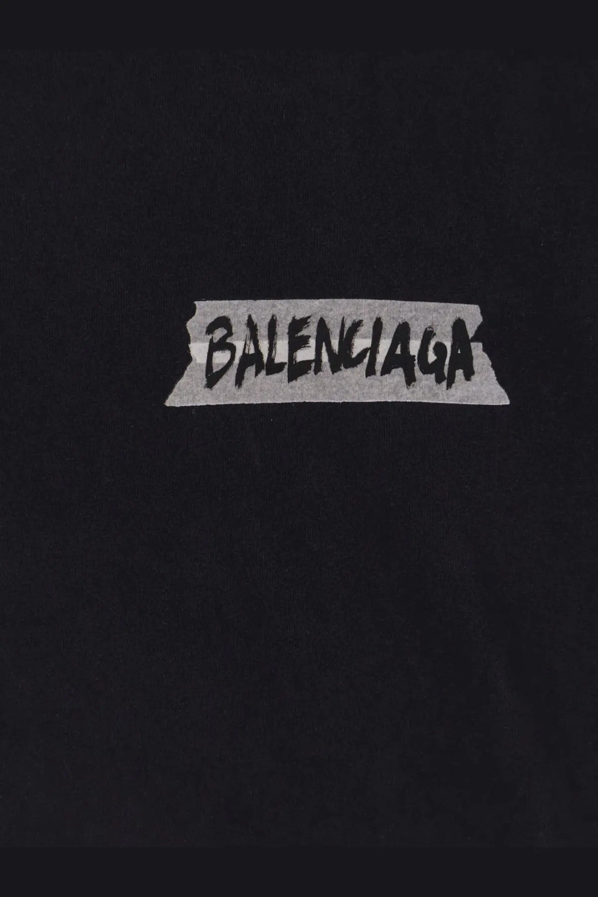 Black balenciaga women’s cotton t shirt with used effect featuring a graffiti style logo on torn tape graphic
