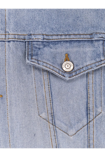 Light-wash denim jacket pocket with a silver Balenciaga jeans button on a Balenciaga women’s washed out denim jacket blue
