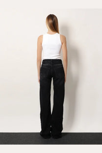 Balenciaga women’s wide leg black denim trousers showing back side with straight-cut silhouette and classic pockets