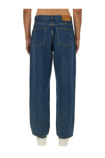 Dark blue denim bally men’s baggy fit jeans with classic five-pocket design and brown leather brand patch at waistband