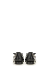 Bally women’s moccasin plume black patent leather loafers with gold-tone hardware and classic moccasin design