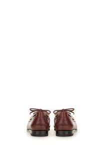 Bally women’s moccasin plume brown burgundy leather boat shoes with black rubber soles and matching laces