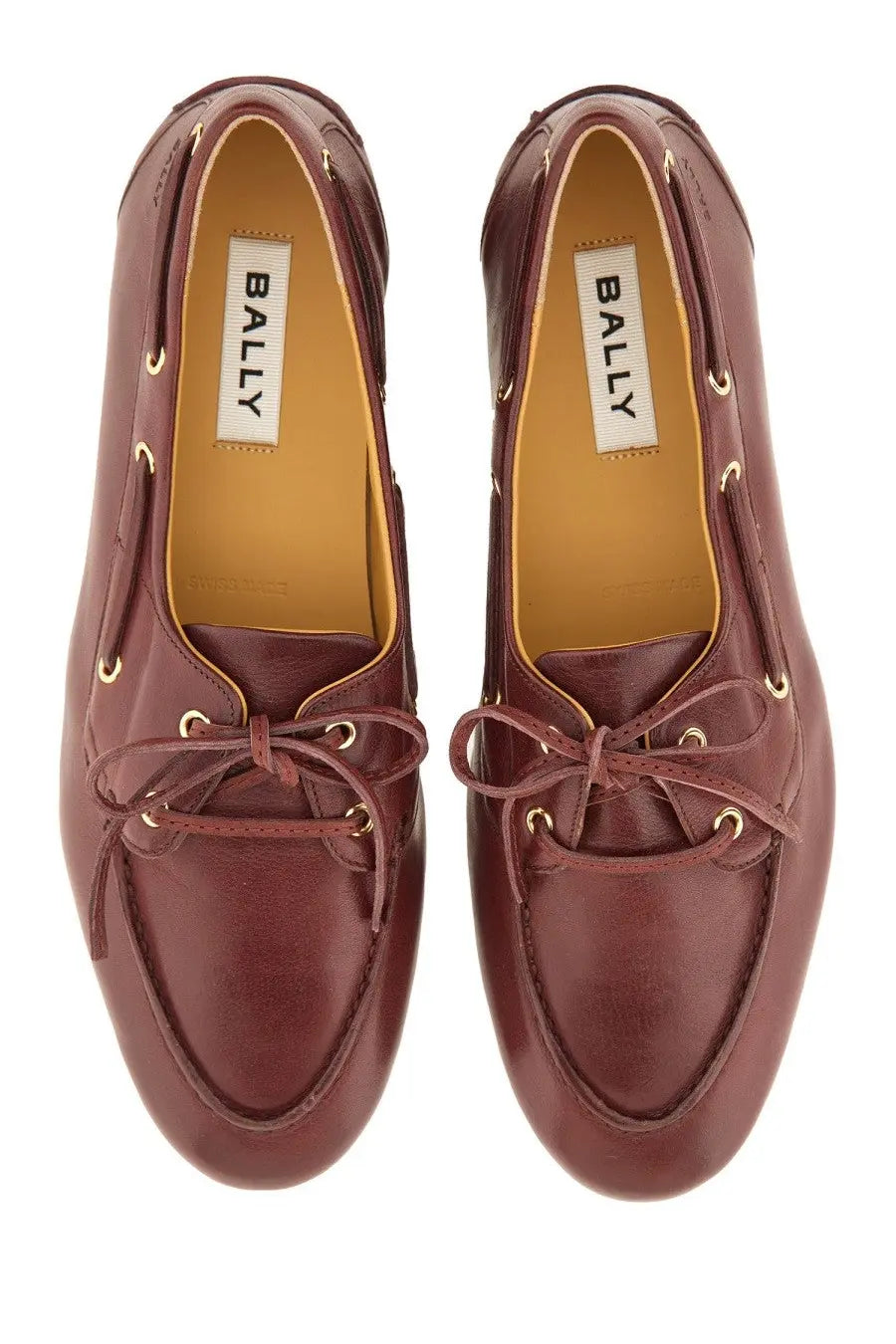 Bally women’s moccasin plume maroon leather boat shoes with gold tone eyelets and matching laces